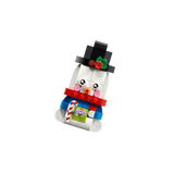 LEGO snowman ornament in a black top hat and red scarf holding a candy cane and green gift