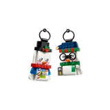 Two LEGO snowman ornaments with black hanging loops, one wearing glasses and a blue hat and one in a black top hat
