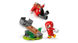 Knuckles standing beside the green and brown catapult as it launches Dr. Eggman into the air