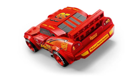Rear angled view of  a red LEGO Speed Champions Lightning McQueen model car showing rear body details and printed graphics 