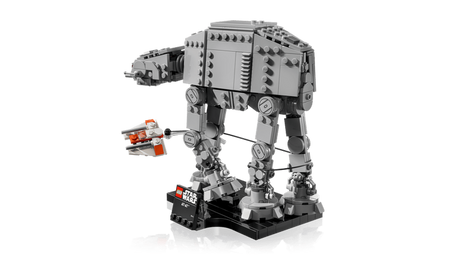 Side view of the completed LEGO Star Wars AT-AT walker on its black display stand, with the orange and white Rebel Snowspeeder and tow cable around the walker's legs.