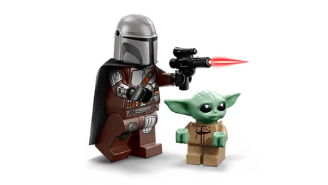 LEGO Star Wars minifigures showing The Mandalorian in brown armour with helmet, cape, and blaster firing a red bolt, standing next to the Grogu figure with green head and tan outfit