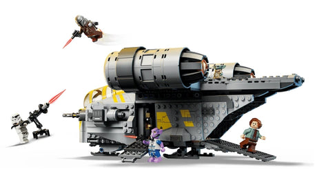 Side view of the LEGO Razor Crest with its ramp lowered, Grogu on top, The Mandalorian flying above and minifigures positioned around the ship