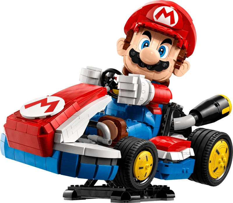 Rear three quarter view of Mario seated in the LEGO Standard Kart with yellow wheels, black exhaust pipes and red rear spoiler