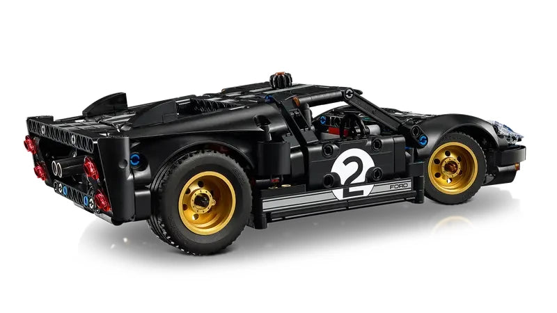 Side view of the LEGO Technic 1966 Ford GT40 MKII race car showing black and silver livery, number 2 door marking, and gold wheels