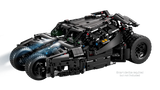 Front three quarter view of the LEGO Technic Batmobile Tumbler 42239 with a blue light effect across the front