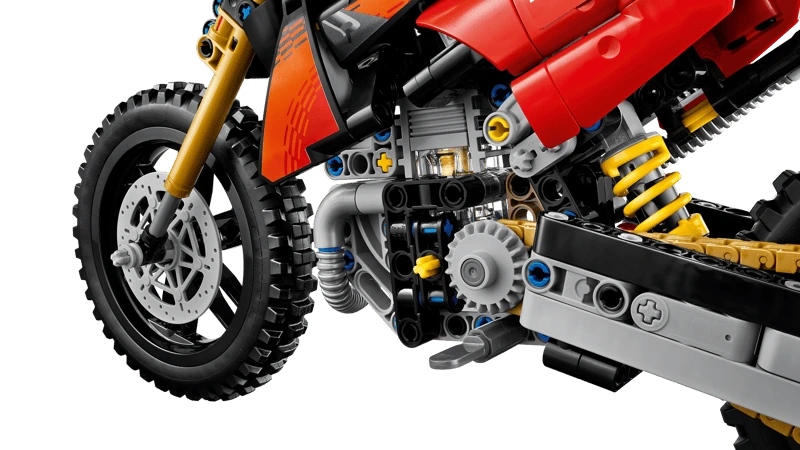 Close-up of the LEGO Technic Ducati Desmo450 MX Factory Motorcycle 42238 engine, front wheel and yellow rear suspension spring