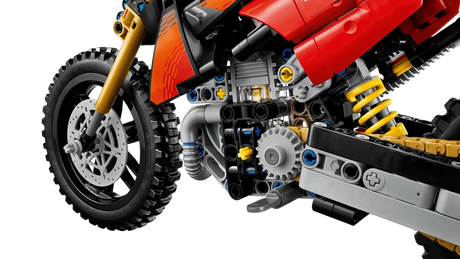 Close-up of the LEGO Technic Ducati Desmo450 MX Factory Motorcycle 42238 engine, front wheel and yellow rear suspension spring