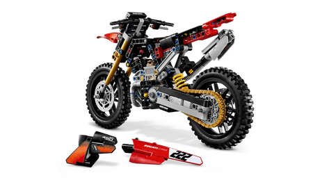 LEGO Technic Ducati Desmo450 MX Factory Motorcycle 42238 with the seat and red body panels removed and placed in front