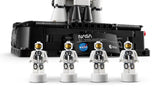 Four LEGO Technic NASA astronaut nanofigures lined up in front of the Artemis rocket display base