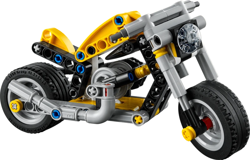 Side view of built LEGO Technic Yellow Motorcycle 42225 showing yellow body panels, black wheels, chain drive and 3 piston engine
