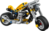 Side view of built LEGO Technic Yellow Motorcycle 42225 showing yellow body panels, black wheels, chain drive and 3 piston engine