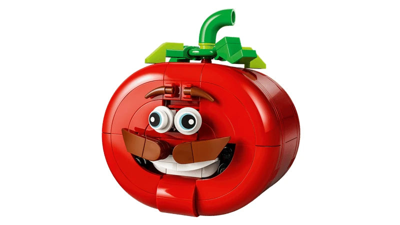 LEGO red tomato head model front view with green stem, eyes, moustache and smiling mouth