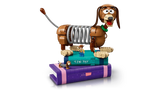 LEGO Slinky Dog model displayed on stacked purple and turquoise book builds with small character figures