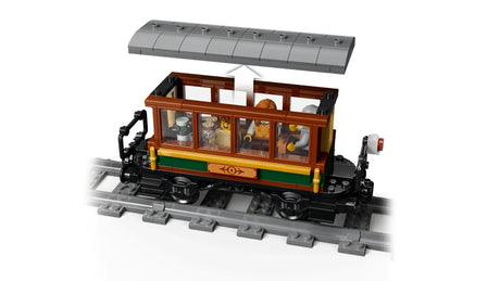LEGO passenger car on track with grey roof, brown seats and minifigures inside