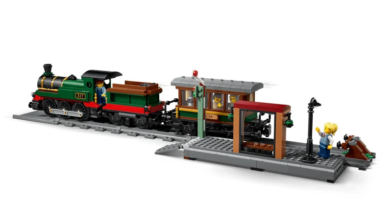 LEGO steam train beside station platform with minifigures, lamppost, bench and track