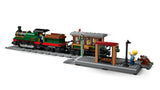 LEGO steam train beside station platform with minifigures, lamppost, bench and track
