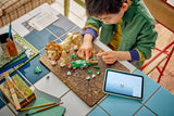 Child building LEGO Wild Animals: Majestic Lion with pieces, instructions and tablet on a table