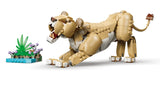 LEGO lioness model stretching beside a small water and flower habitat build