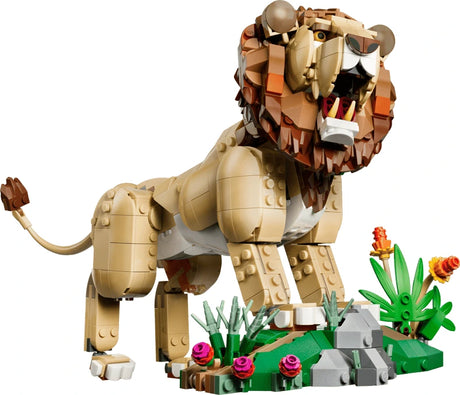 LEGO lion model roaring beside a savanna habitat build with plants and rocks
