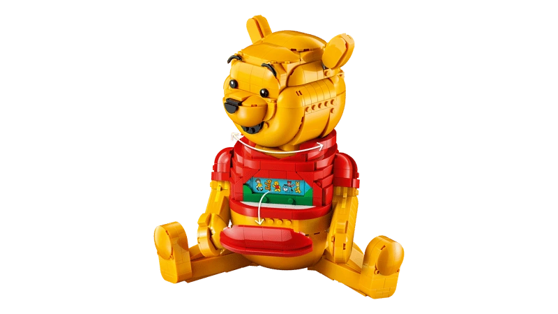 LEGO Winnie the Pooh 43300 side view showing the seated Winnie the Pooh figure with turning head arrows and an opened front panel revealing a hidden picture strip