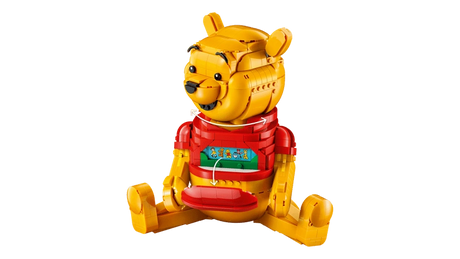 LEGO Winnie the Pooh 43300 side view showing the seated Winnie the Pooh figure with turning head arrows and an opened front panel revealing a hidden picture strip