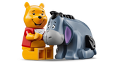 LEGO Winnie the Pooh 43300 Winnie the Pooh minifigure sitting beside Eeyore figure