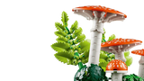 Close up of LEGO red fly agaric mushrooms with white spots and green fern pieces