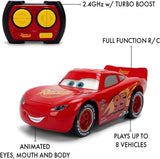 Lightning McQueen Animated RC with red and yellow remote controller, showing 2.4 GHz turbo boost control and labels identifying animated eyes, mouth and body movements.
