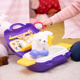 Close view of a child brushing the white plush puppy inside the open Little Pet Parlour Carry Case with the toy hair dryer and grooming accessories visible