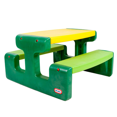 Green and yellow Little Tikes picnic table with bench seats shown on white background