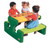 Three children drawing together at the Little Tikes picnic table with crayons and paper