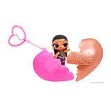 L.O.L. Surprise Music Festival Headliners Tots miniature doll with dark braided hair and a blue butterfly patterned outfit, standing inside an opened pink and rose gold heart capsule with a pink heart shaped keychain.