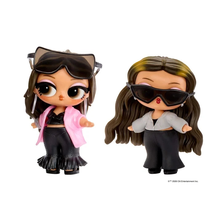 Two L.O.L. Surprise Music Festival Headliners Tots dolls with long brown hair and oversized black sunglasses, one wearing a pink jacket with black flared trousers and the other wearing a grey jacket with black trousers.
