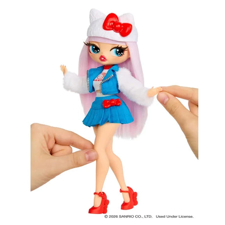L.O.L. Surprise O.M.G. Hello Kitty doll with long pink hair, a white cat ear hat, blue jacket and skirt, fluffy white sleeves and red heels, while two hands position her arms and legs.