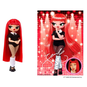 L.O.L. Surprise O.M.G. Music Festival Jennie doll with long bright red hair, a black outfit and fishnet tights, displayed beside a red concert poster featuring doll artwork, a signature and Jennie's photograph.