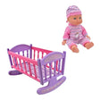 Baby doll with pink outfit and hat beside a purple and pink rocking crib