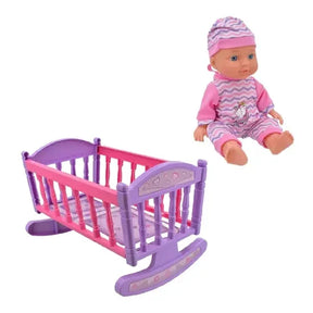 Baby doll with pink outfit and hat beside a purple and pink rocking crib
