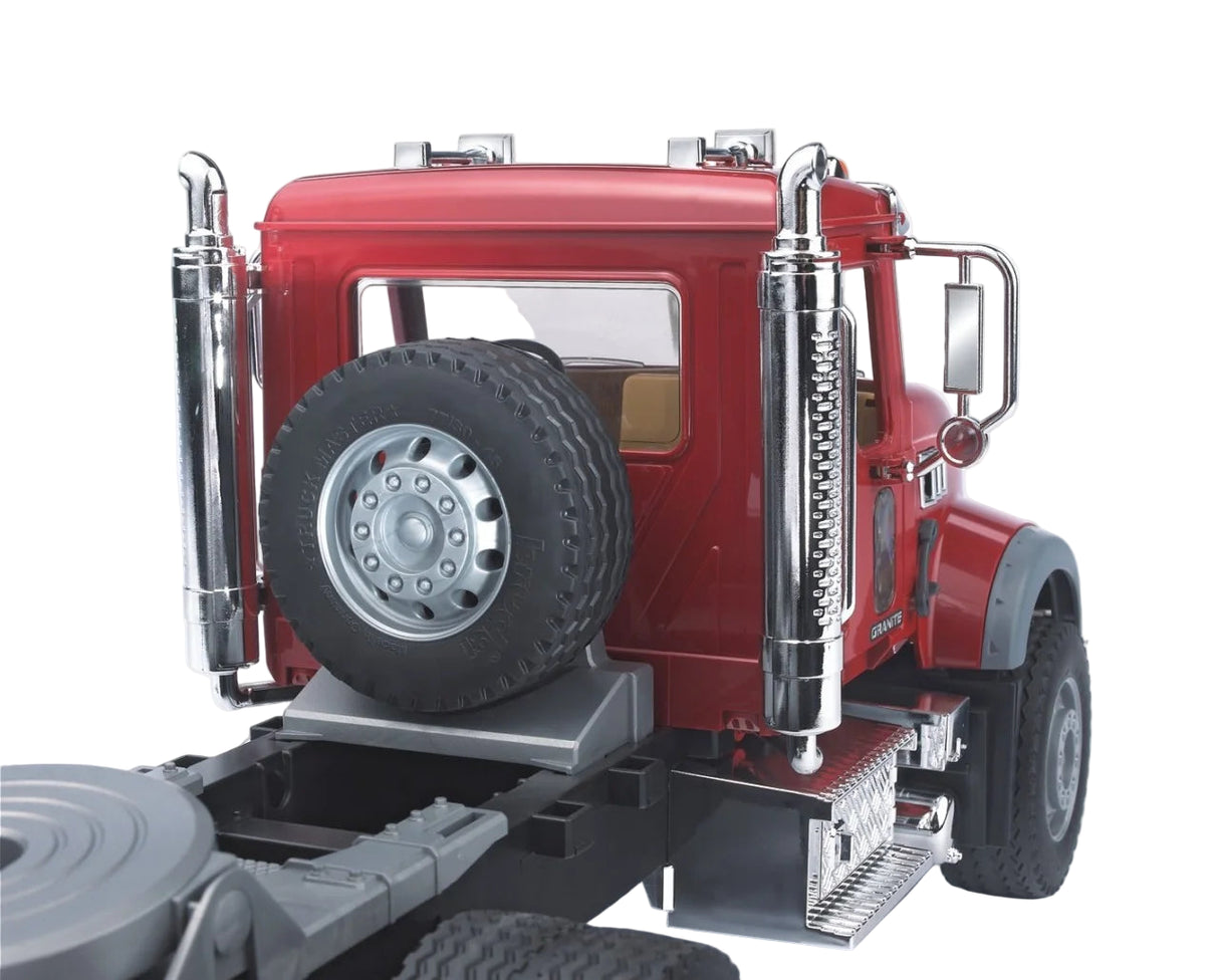 Close view of the MACK Granite toy truck showing the spare tyre, chrome exhaust stacks, and rear cab detailing.
