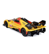 Side view of the yellow Ferrari 499P number 83 RC racing car, showing its low aerodynamic body, black wheels, racing graphics and rear wing.