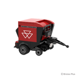Front right view of the BRIXIES Plus Massey Ferguson RB F round baler showing the drawbar, pickup mechanism, red housing and front support wheel