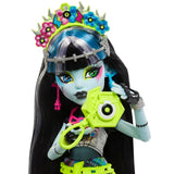 Closeup of Frankie Stein doll holding instant camera with crown – Ireland