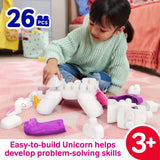 Child building the MEGA BLOKS unicorn with large white, pink and purple blocks