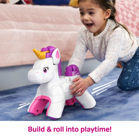 Child pushing the completed MEGA BLOKS unicorn across the floor on its rolling wheels