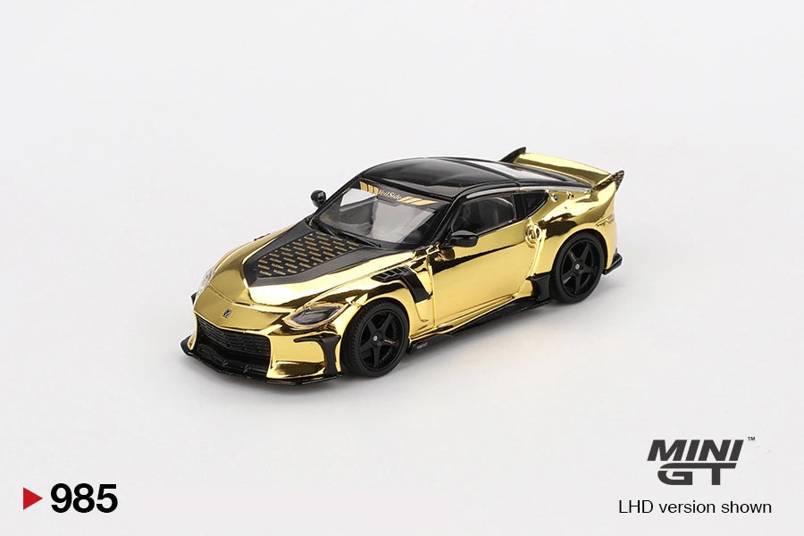 Mini GT Nissan Z VeilSide FFZ400 Gold Chrome front three quarter view showing the patterned black bonnet, gold front bumper, black splitter, side vents and five spoke wheels