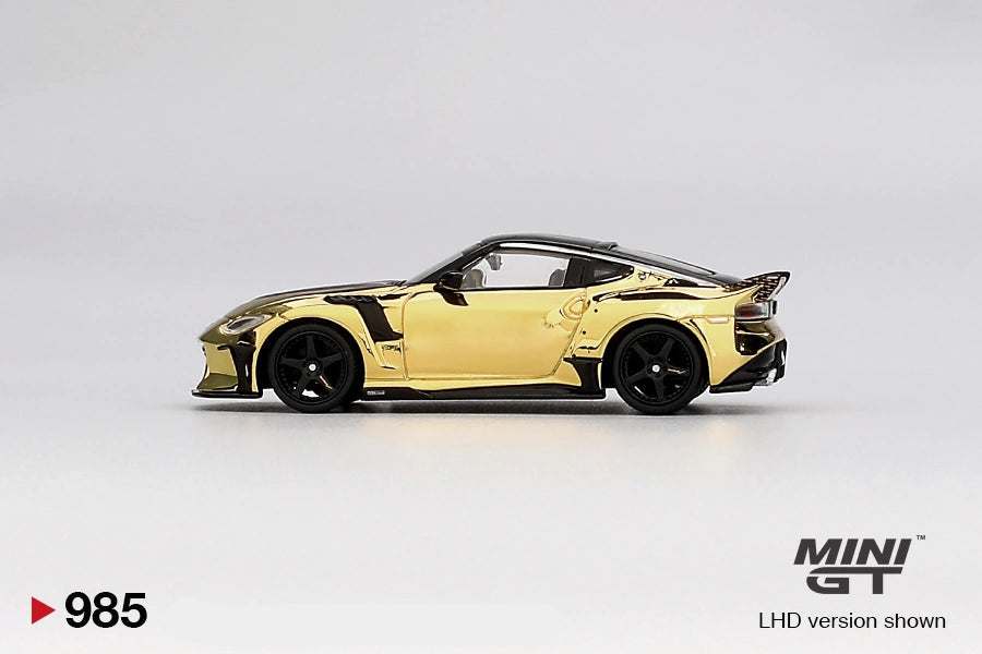 Side profile of Mini GT Nissan Z VeilSide FFZ400 Gold Chrome showing reflective gold bodywork, black roof, five spoke wheels, widened arches and rear spoiler