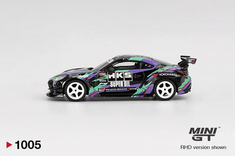 Side profile of Mini GT Toyota GR86 HKS Type R showing black bodywork, purple and green HKS graphics, white five spoke wheels, HKS Super Oil branding and large rear wing
