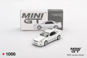 Mini GT Nissan Skyline GT-R R32 VeilSide Combat C-I White diecast car shown from the front three quarter angle, with silver wheels, grey side graphics and its illustrated Mini GT collector box
