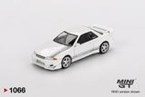 Mini GT Nissan Skyline GT-R R32 VeilSide Combat C-I White front three quarter view showing the modified front bumper, silver five spoke wheels, VeilSide bonnet graphics and raised rear spoiler