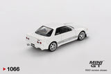 Rear three quarter view of Mini GT Nissan Skyline GT-R R32 VeilSide Combat C-I White showing four round taillights, rear spoiler, silver wheels, white bodywork and grey side stripes